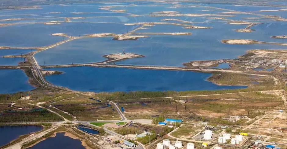 Aerial view of remote oilfield power units with SCADA signals, digital twin monitoring and distributed energy infrastructure