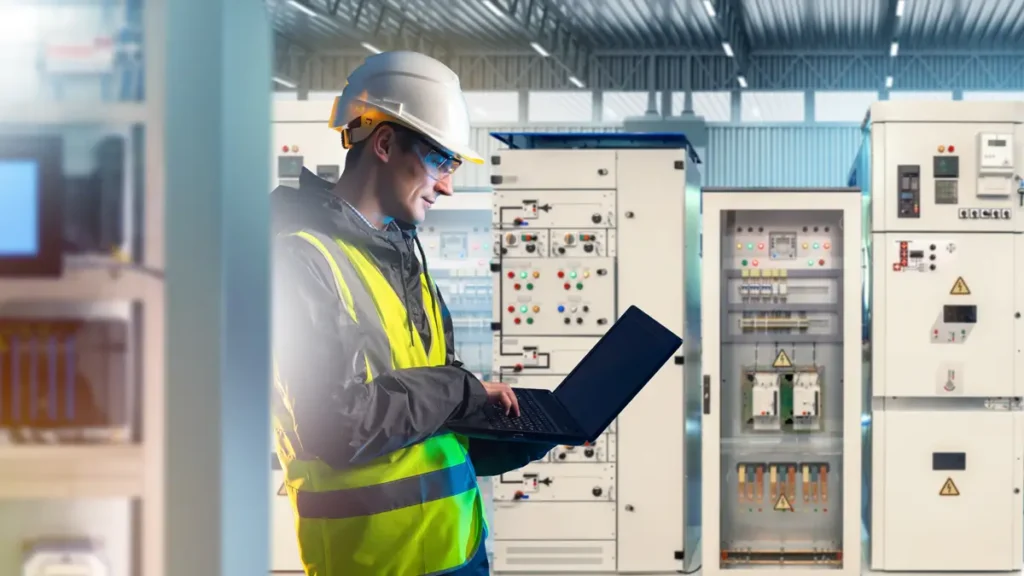 Industrial engineer checking electrical panels in power room using tablet for energy monitoring