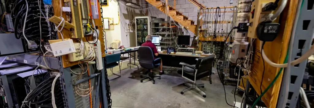 Engineer assessing legacy SCADA hardware, control cabinets, wiring, and system dependencies before modernization